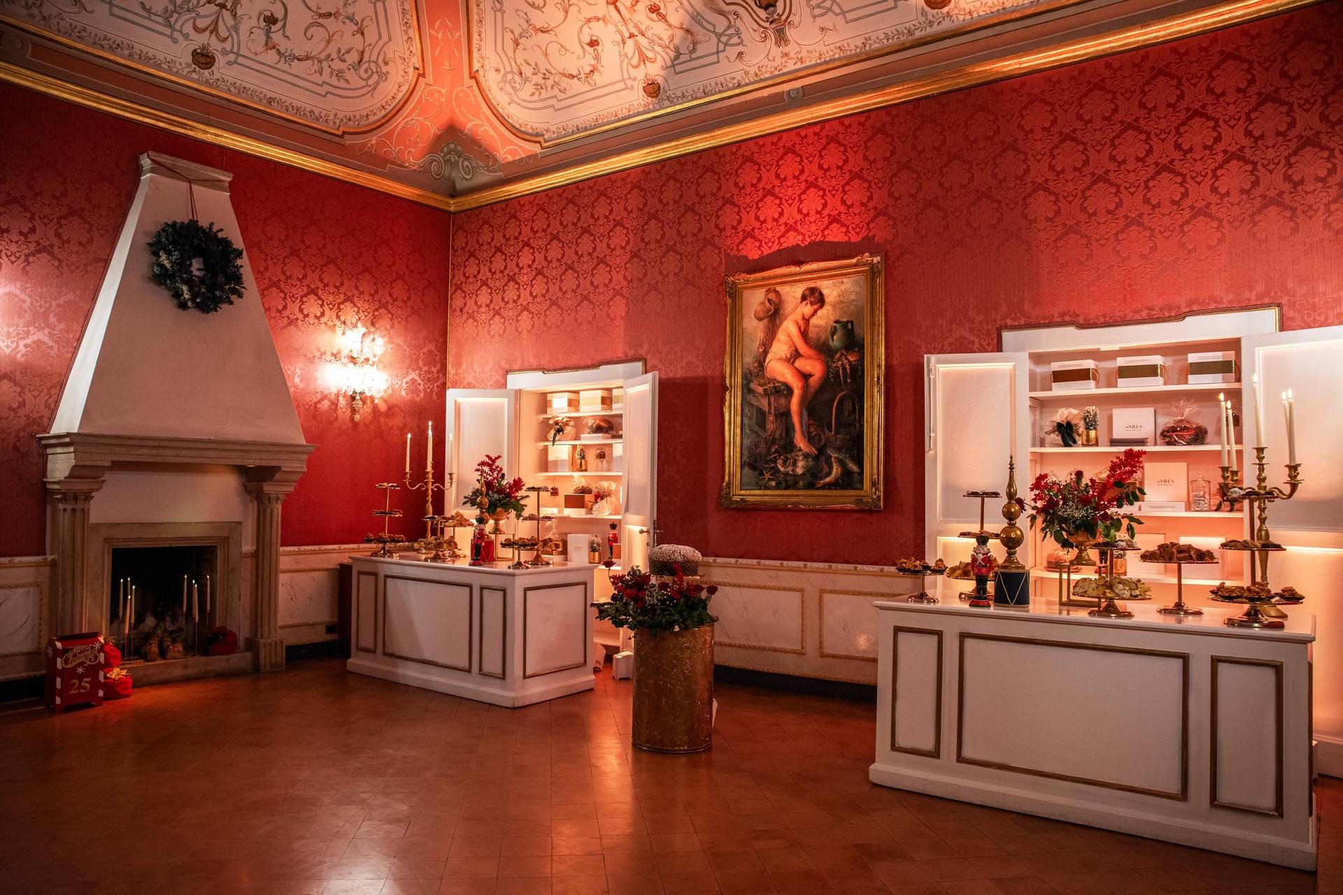 Salone rosso con camino e allestimento dolci natalizi
